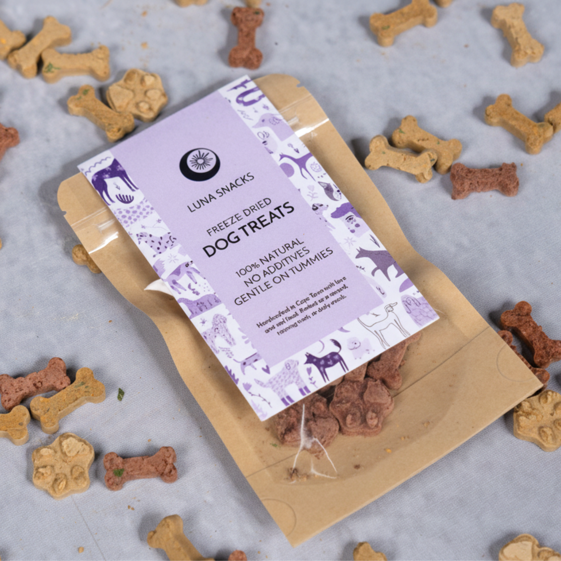 Luna Snacks healthy freeze-dried dog treats package with bone and paw shaped treats scattered around